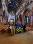 The Cumbria community flag is unveiled in the nave of Carlisle Catherdral on 5 September 2025