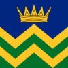 The Cumbria community flag – a gold crown on a blue field above horizontal zigzag lines of alternate green and yellow