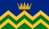 The Cumbria community flag – a gold crown on a blue field above horizontal zigzag lines of alternate green and yellow